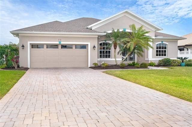 view of front of house featuring a garage and a front yard