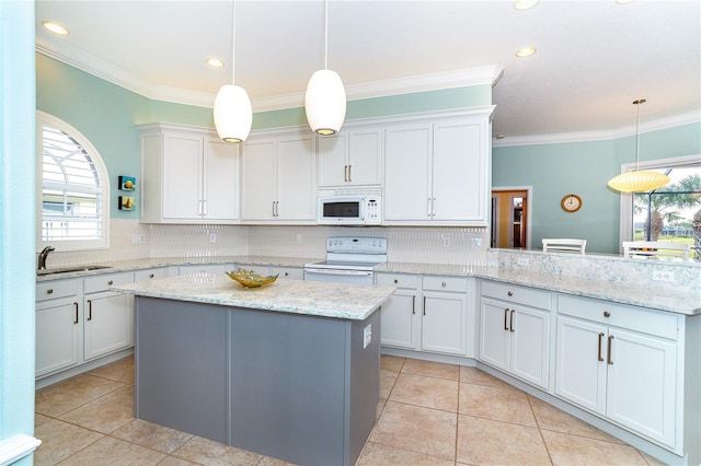 kitchen with white cabinets, white appliances, decorative light fixtures, and kitchen peninsula