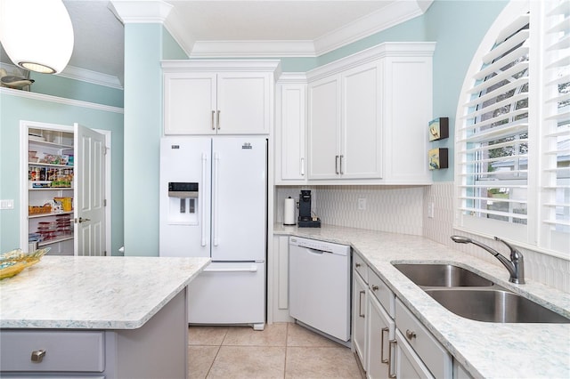 kitchen with white cabinets, light tile patterned flooring, white appliances, and sink