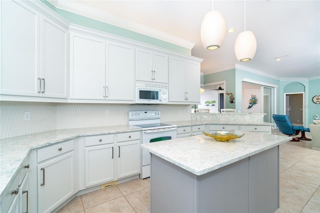 kitchen featuring white cabinets, decorative light fixtures, and white appliances