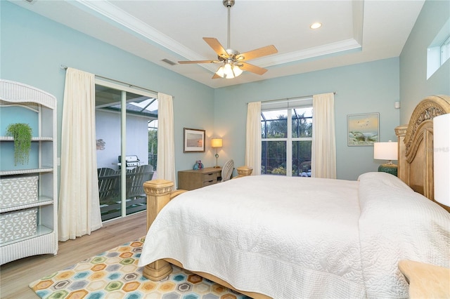 bedroom featuring ceiling fan, a raised ceiling, crown molding, access to outside, and light wood-type flooring