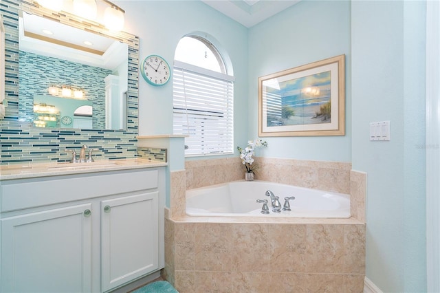 bathroom featuring vanity, tiled bath, and backsplash