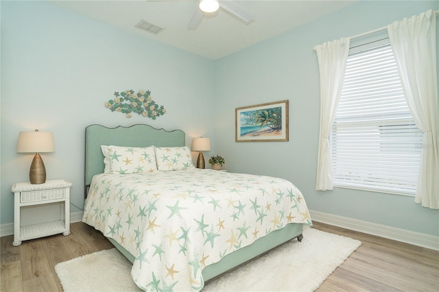 bedroom with hardwood / wood-style floors and ceiling fan