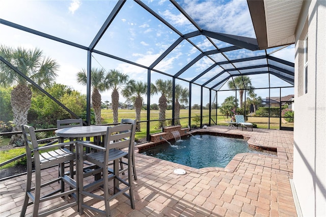 view of pool with a patio area, pool water feature, and glass enclosure