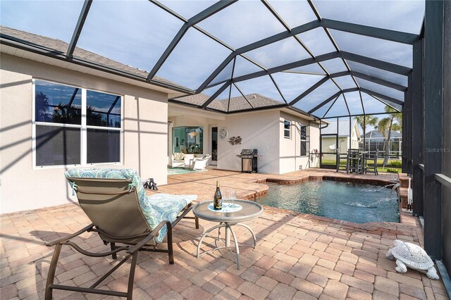 view of pool featuring a lanai, a grill, pool water feature, and a patio