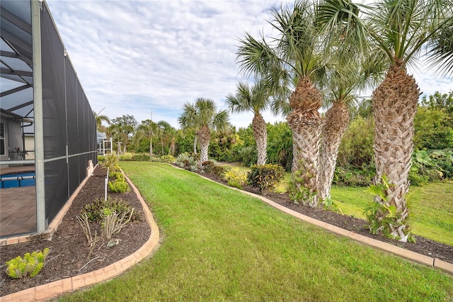 view of yard featuring glass enclosure