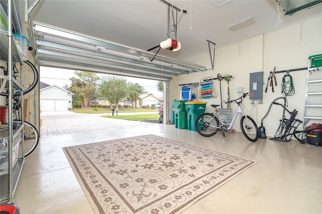 garage featuring electric panel and a garage door opener