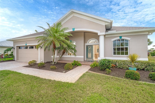 view of front of house featuring a garage and a front lawn