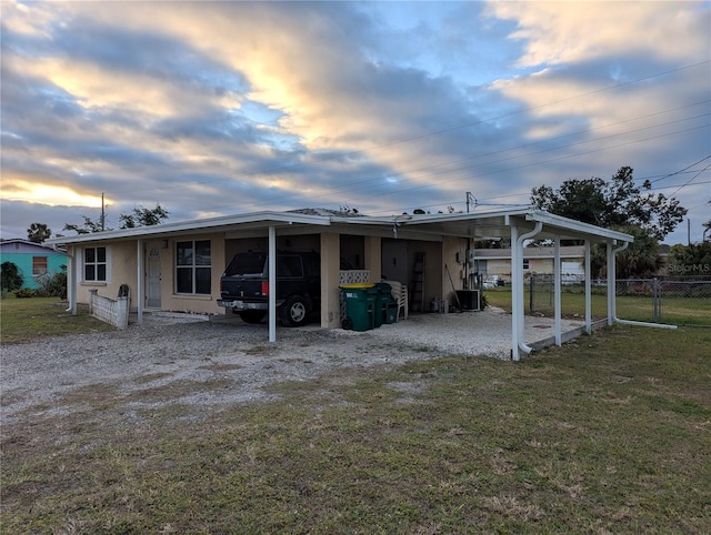 exterior space with a carport and a yard