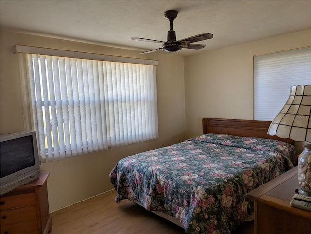 bedroom with light hardwood / wood-style flooring and ceiling fan