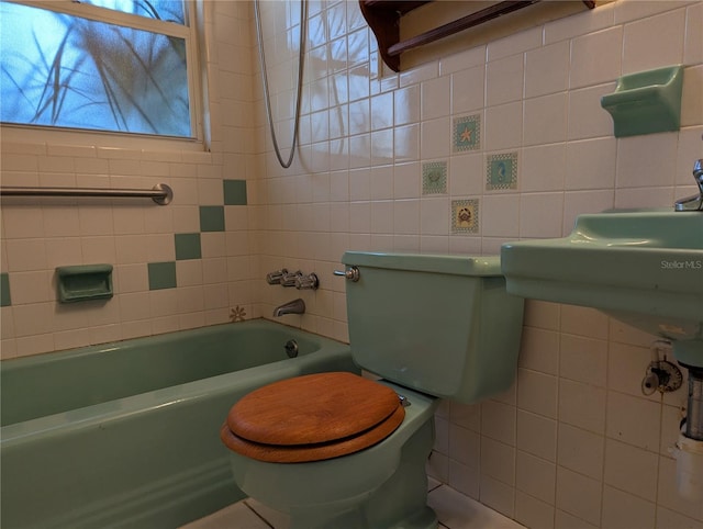 bathroom featuring toilet and tile walls