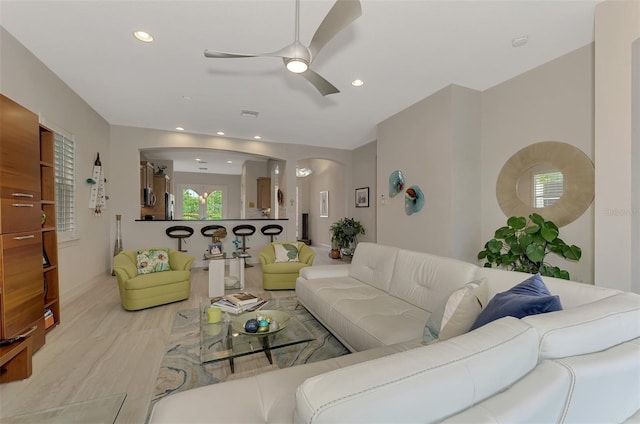 living room featuring ceiling fan and light wood-type flooring