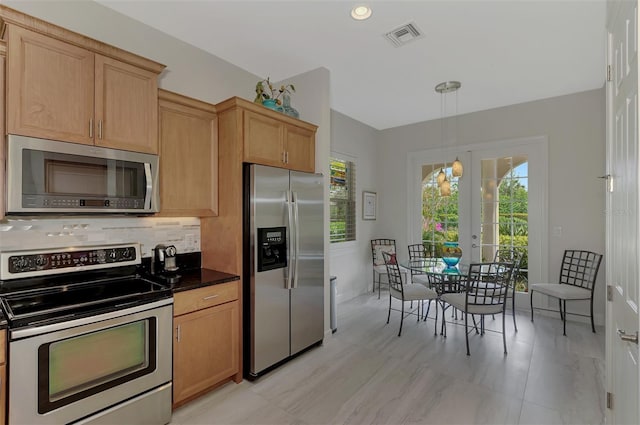 kitchen with appliances with stainless steel finishes, hanging light fixtures, french doors, light brown cabinets, and backsplash