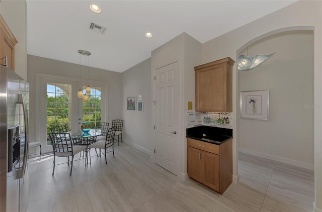 tiled dining room featuring a chandelier