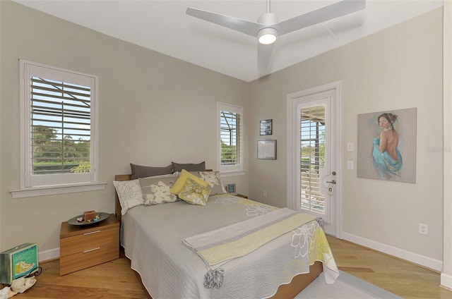 bedroom with light wood-type flooring, ceiling fan, and access to exterior