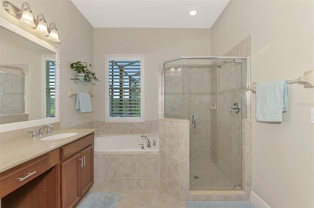 bathroom featuring tile patterned flooring, plus walk in shower, and vanity