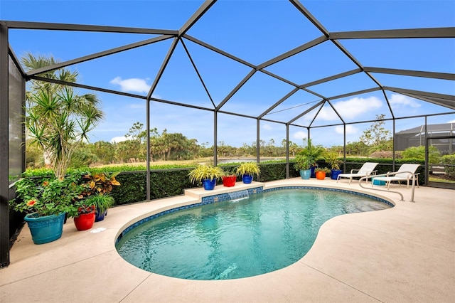 view of swimming pool featuring a lanai and a patio area