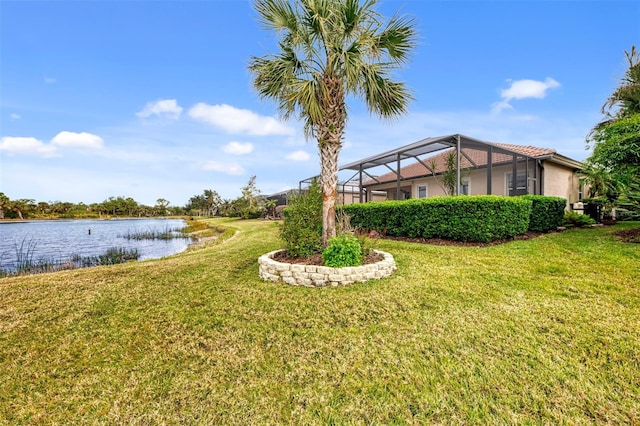 view of yard featuring a lanai and a water view