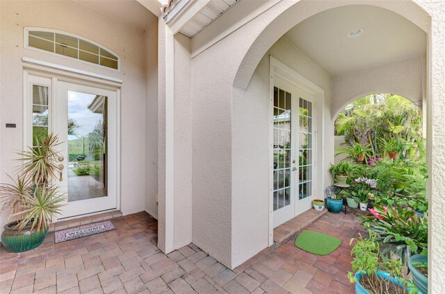 doorway to property with stucco siding and french doors
