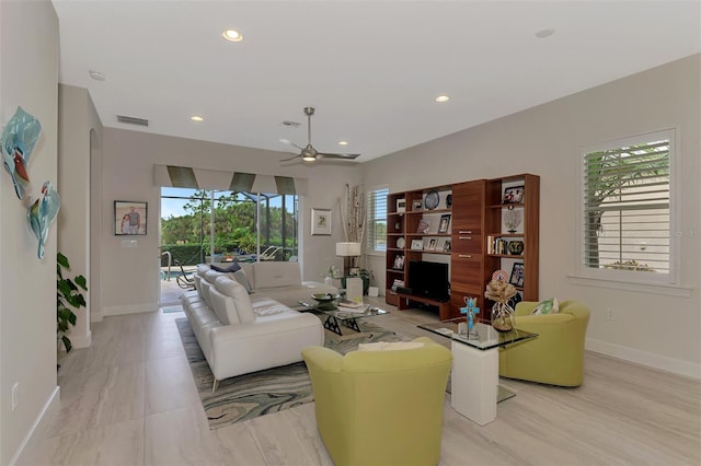 living room with visible vents, baseboards, ceiling fan, recessed lighting, and arched walkways