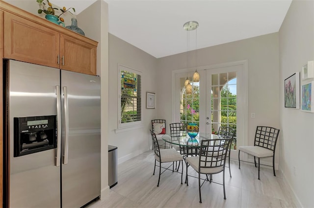 dining room featuring baseboards and french doors