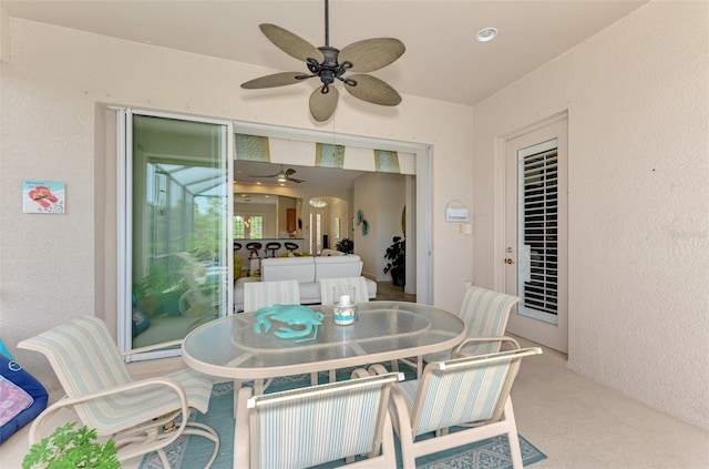 view of patio with outdoor dining space and ceiling fan