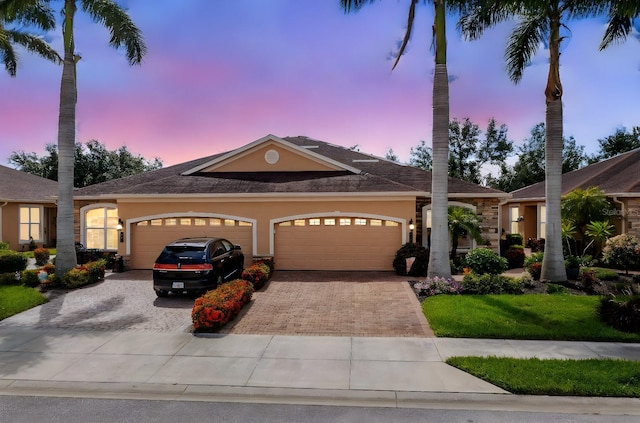 view of front facade with a lawn and a garage