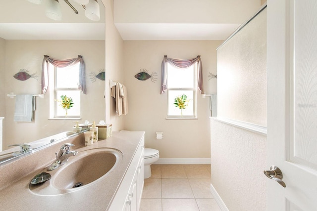 full bathroom featuring tile patterned floors, toilet, vanity, and a wealth of natural light
