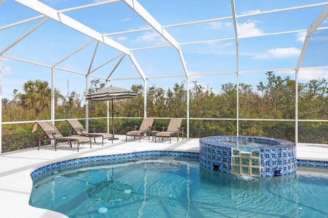 view of swimming pool featuring a patio, a pool with connected hot tub, and a lanai