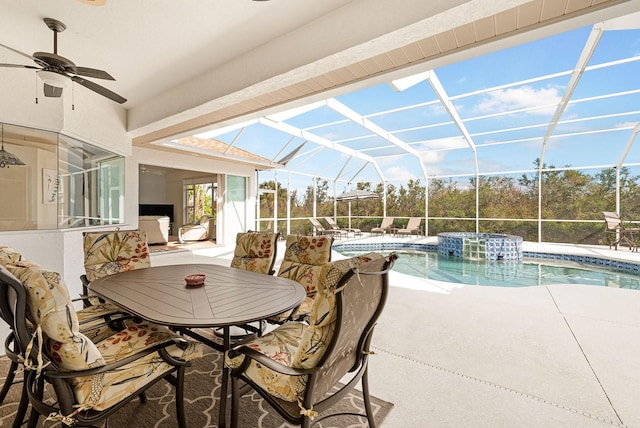 view of patio / terrace with glass enclosure, an outdoor pool, and ceiling fan