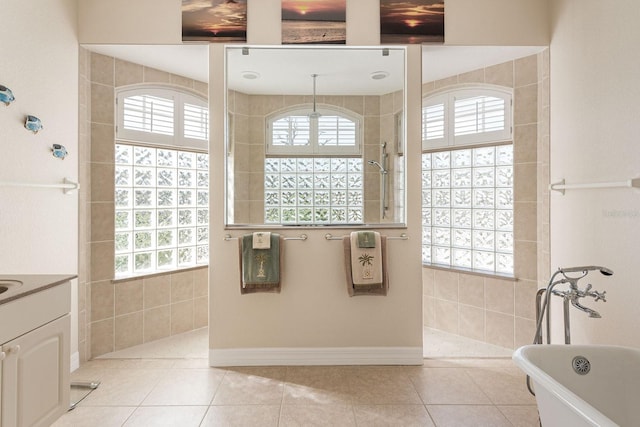 full bath featuring vanity, tile patterned floors, a soaking tub, and walk in shower