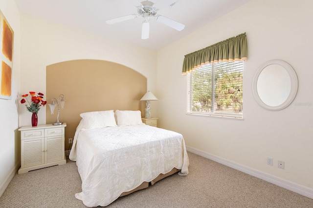 carpeted bedroom featuring baseboards and a ceiling fan