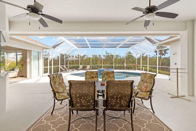 view of patio / terrace with a lanai, an outdoor pool, and a ceiling fan