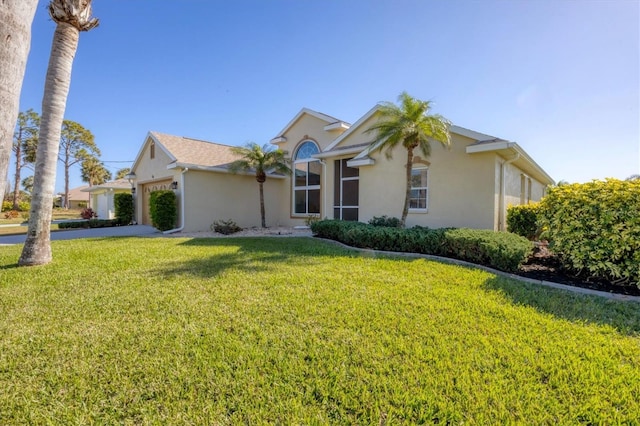 single story home featuring a garage and a front lawn