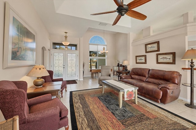 living room featuring ceiling fan, french doors, and light tile patterned floors