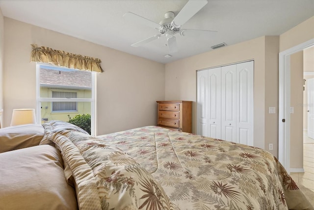 bedroom with ceiling fan and a closet