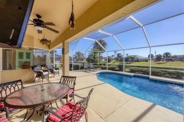 view of pool featuring ceiling fan, a patio area, and a lanai