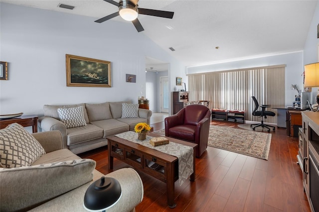 living room featuring vaulted ceiling, ceiling fan, and dark wood-type flooring