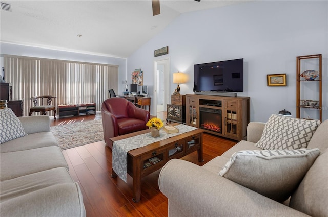 living room featuring wood-type flooring, ceiling fan, and lofted ceiling