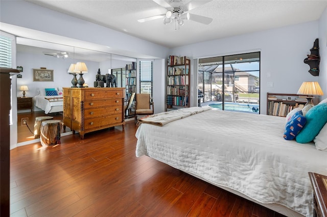 bedroom with access to exterior, ceiling fan, dark hardwood / wood-style flooring, and a textured ceiling