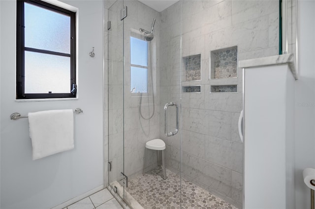 bathroom with tile patterned flooring and a shower with door