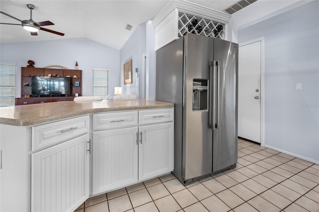 kitchen featuring vaulted ceiling, white cabinetry, ceiling fan, and stainless steel refrigerator with ice dispenser