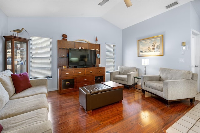 living room featuring ceiling fan, dark hardwood / wood-style flooring, and vaulted ceiling