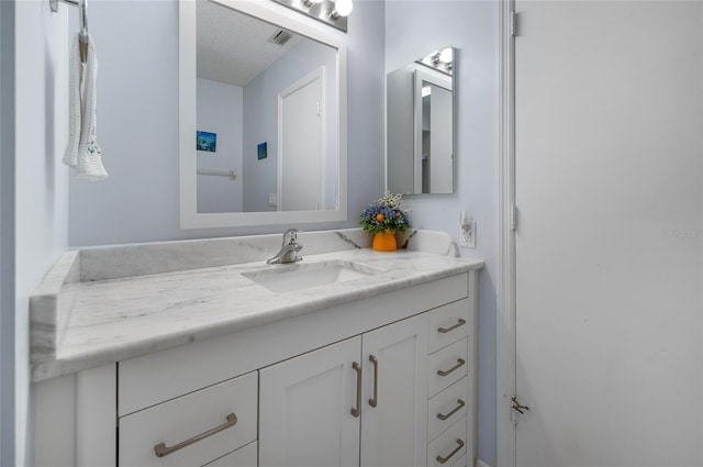 bathroom featuring vanity and a textured ceiling