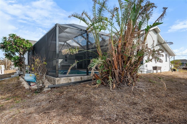 view of side of property with glass enclosure