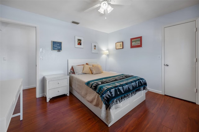 bedroom with dark hardwood / wood-style flooring and ceiling fan