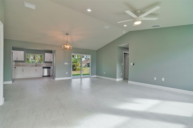 unfurnished living room with ceiling fan, sink, and vaulted ceiling