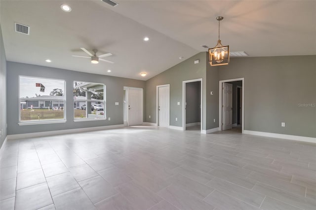 unfurnished room with ceiling fan with notable chandelier and lofted ceiling