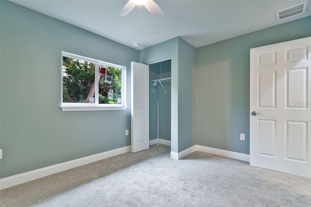 unfurnished bedroom featuring a closet, ceiling fan, and light colored carpet