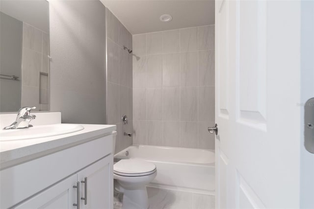 full bathroom with vanity, toilet, and tiled shower / bath combo